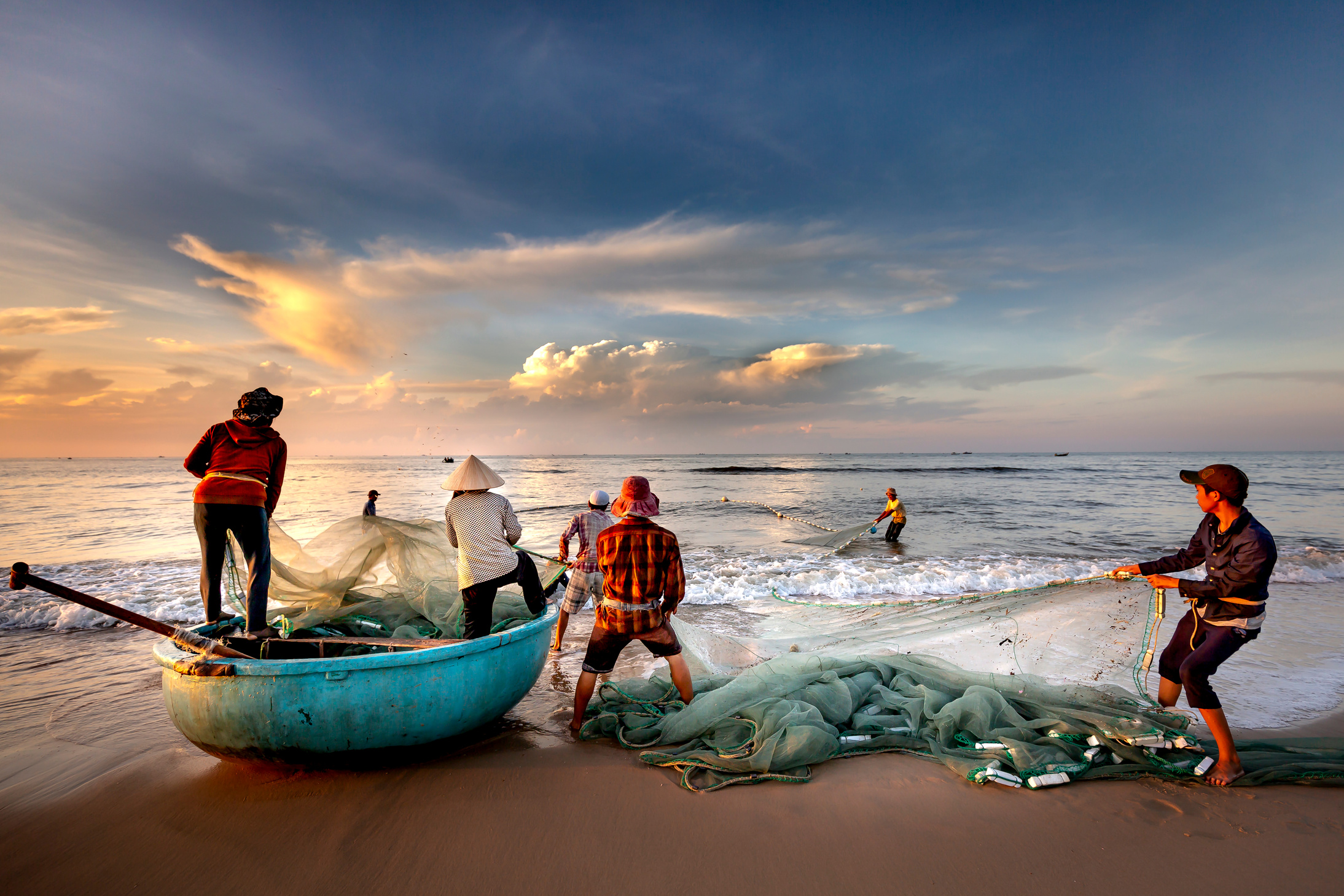 Fishermen Fixing Fishing Nets on the Seashore